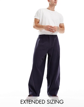 ASOS DESIGN baggy balloon fit cord pants with pleats in navy blue