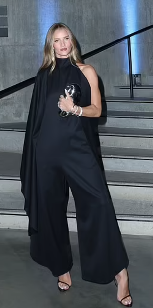 black jumpsuit, silver clutch handbag, and sandals?