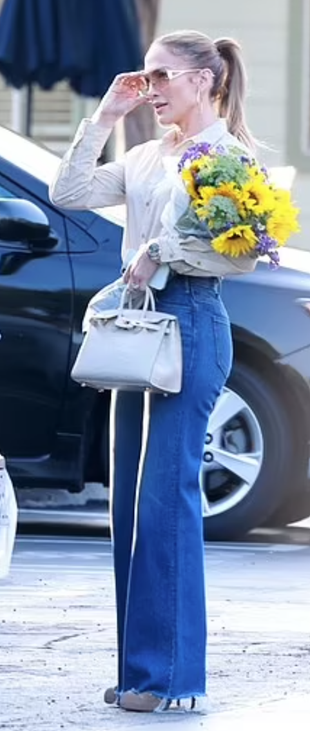 blue jeans, beige boots, sunglasses, hoop jewelry, and tote handbag?