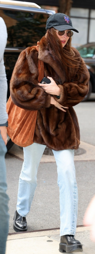 brown jacket, sunglasses, and black boots?