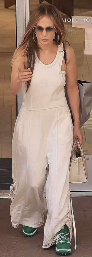 white jumpsuit, green sneakers, and tote handbag?