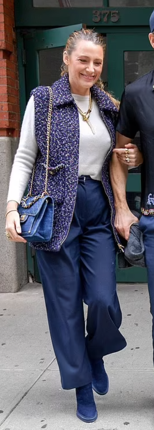 vest, jewelry, blue boots, and handbag?