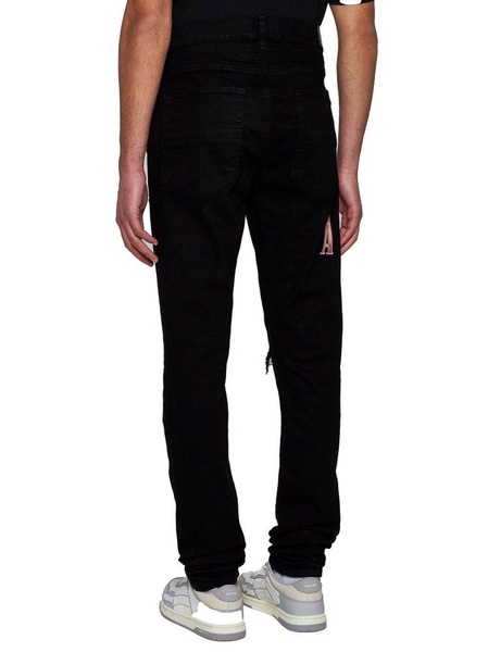 Amiri Logo Patch Distressed Skinny Jeans