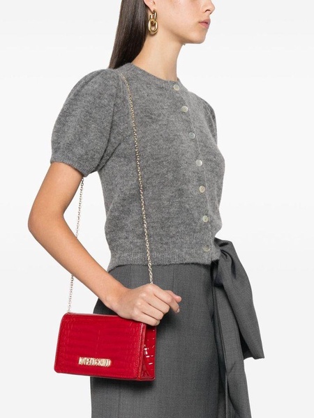 Red crocodile-embossed synthetic leather clutch