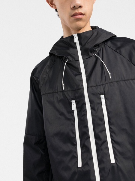 zipped-up hooded windbreaker