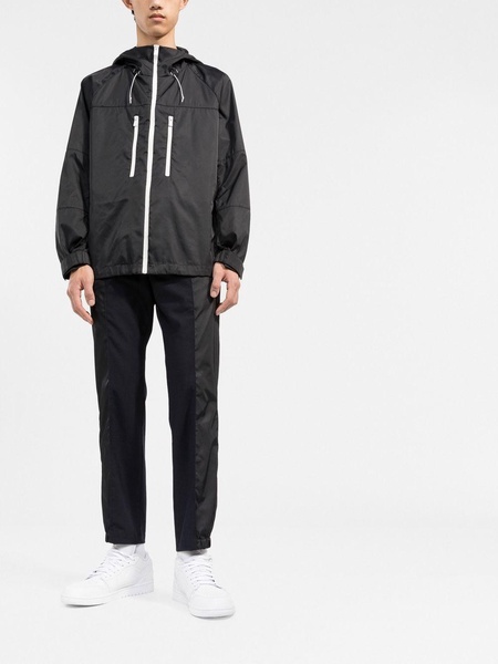 zipped-up hooded windbreaker