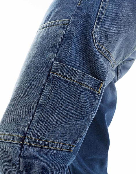 ASOS DESIGN tapered jeans in mid blue wash with carpenter details