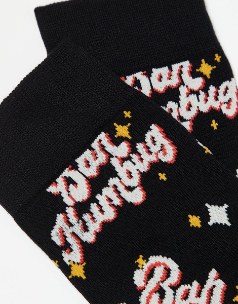 ASOS DESIGN Christmas socks with Bah Humbug slogan in black