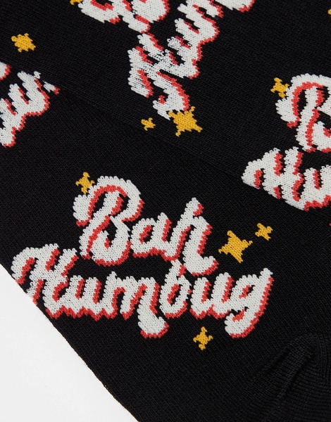 ASOS DESIGN Christmas socks with Bah Humbug slogan in black