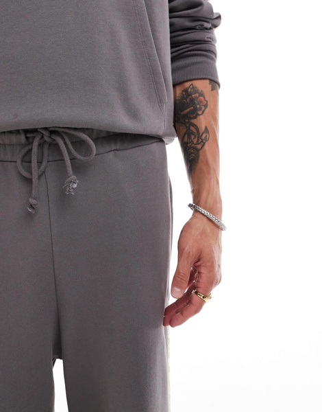 ASOS DESIGN extreme wide leg sweatpants with slanted side tape with text print in charcoal