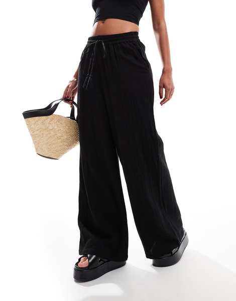 Accessorize wide leg beach pants in black