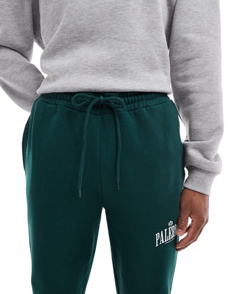 ASOS DESIGN straight leg sweatpants with Palermo print in green