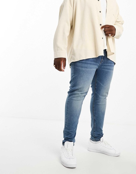 ASOS DESIGN power stretch jeans in mid wash