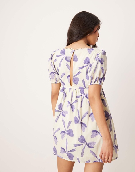 ASOS DESIGN mini smock dress with bow front and lace trims in bow print