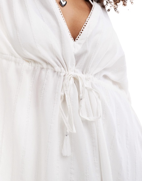 Accessorize beach cover up in white