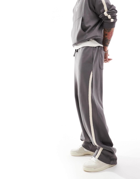 ASOS DESIGN extreme wide leg sweatpants with slanted side tape with text print in charcoal