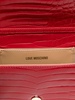 Red crocodile-embossed synthetic leather clutch