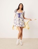 ASOS DESIGN mini smock dress with bow front and lace trims in bow print