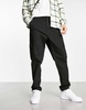 ASOS DESIGN tapered cargo pants with toggles in black