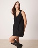 ASOS DESIGN corduroy pinafore mini dress with oversized pockets in black