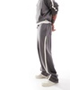 ASOS DESIGN extreme wide leg sweatpants with slanted side tape with text print in charcoal